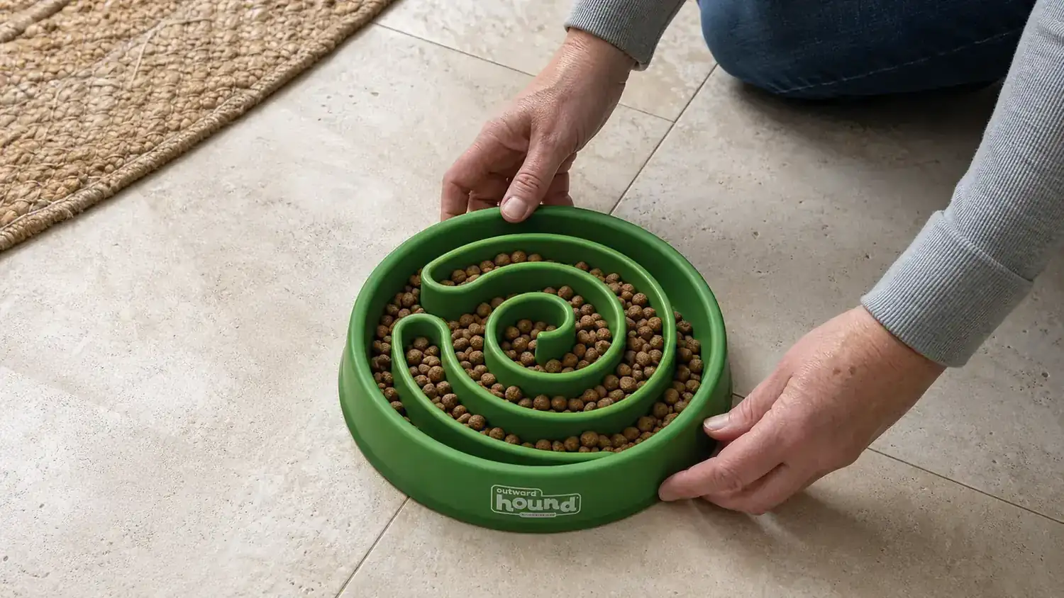 Top-down view of the Outward Hound Fun Feeder Slo Bowl filled with dry kibble showing the raised ridge maze pattern